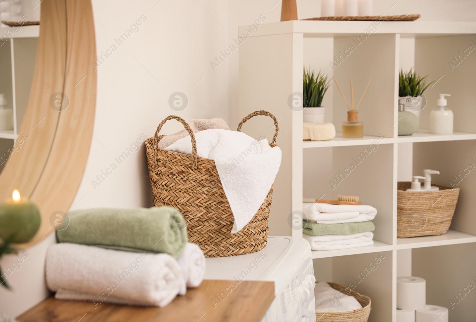 Photo of Fresh towels on wooden table in bathroom