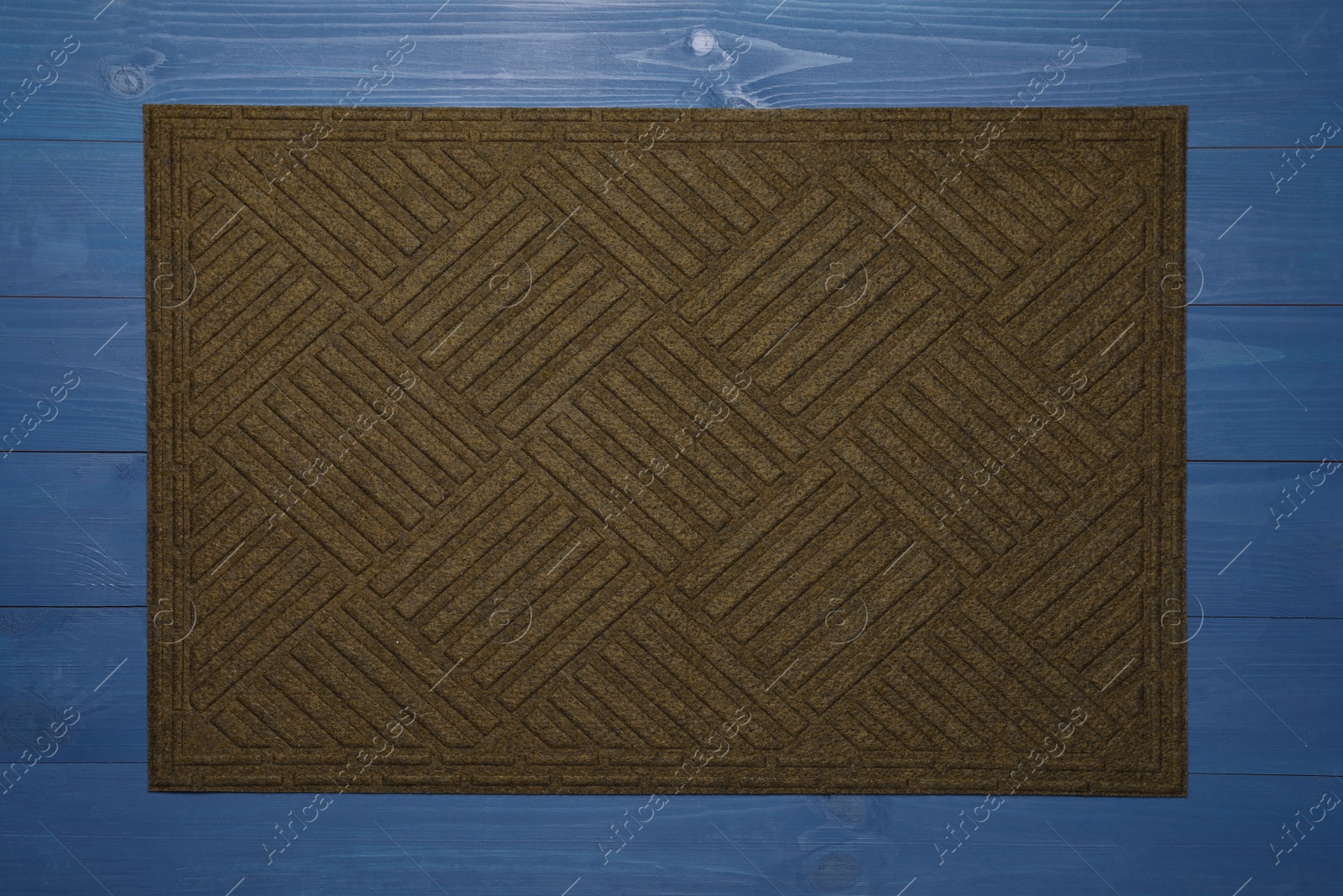 Photo of New clean door mat on blue wooden floor, top view