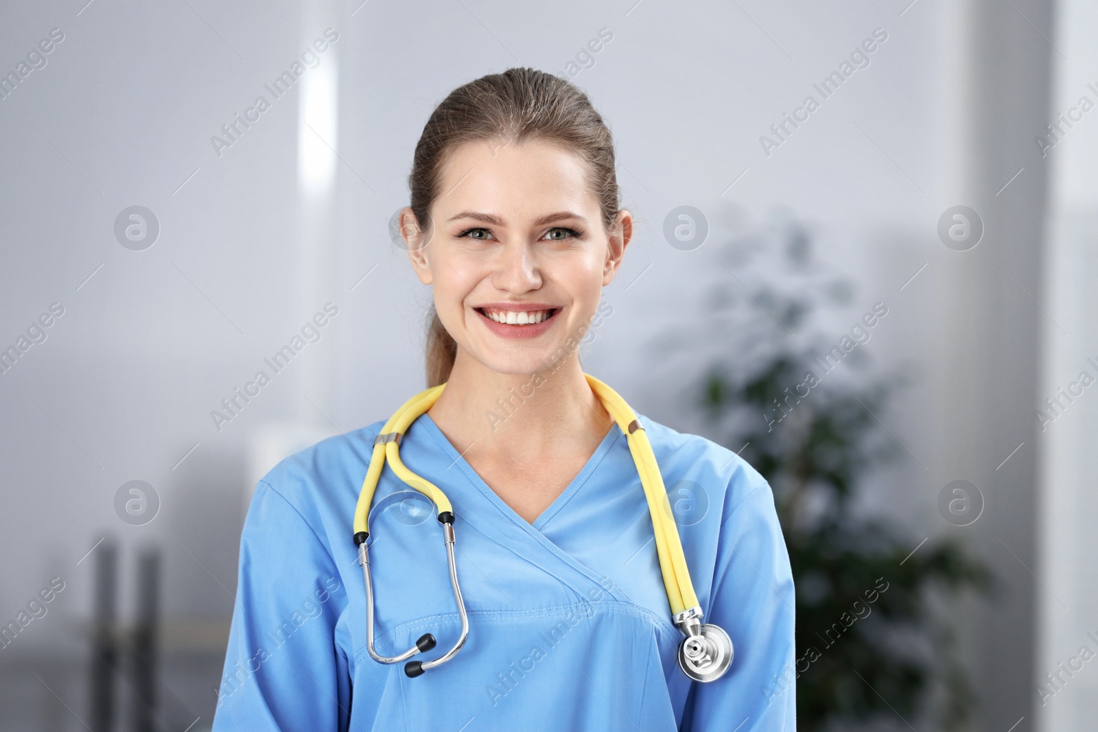 Photo of Portrait of young medical assistant with stethoscope in hospital