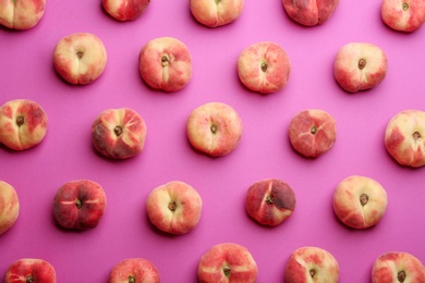 Photo of Fresh donut peaches on pink background, flat lay