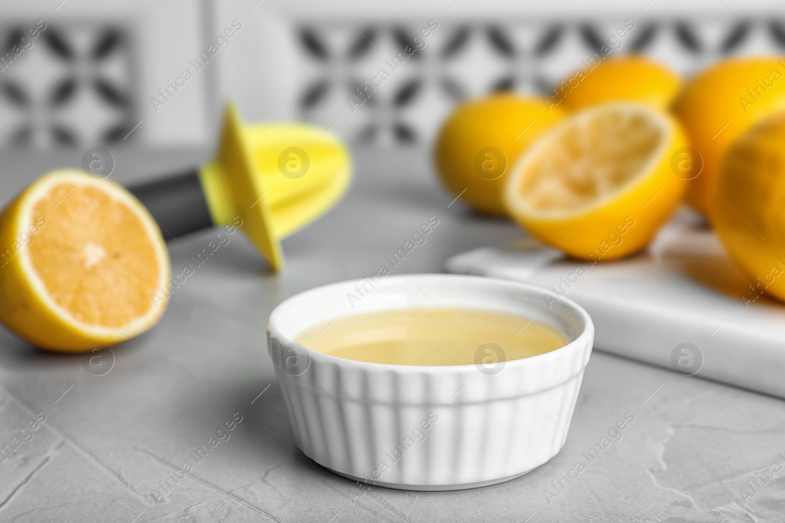 Photo of Freshly squeezed lemon juice in bowl on table