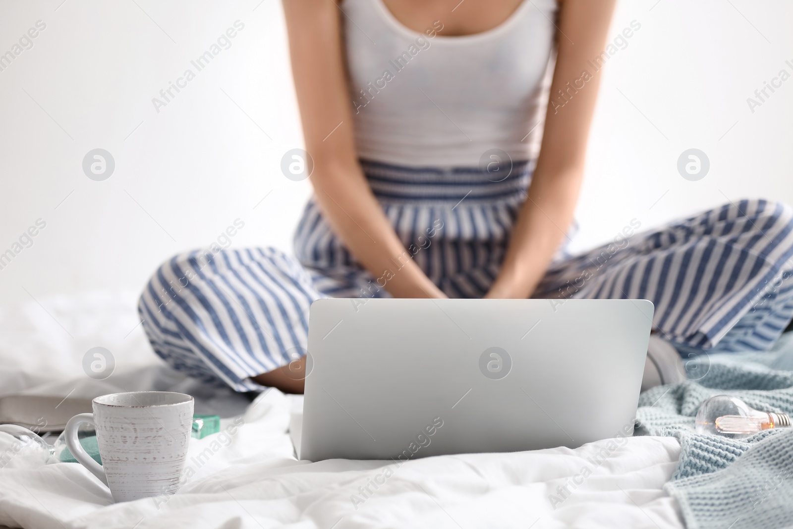 Photo of Female blogger with laptop on bed