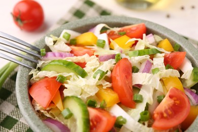 Photo of Tasty salad with Chinese cabbage in bowl on table, closeup