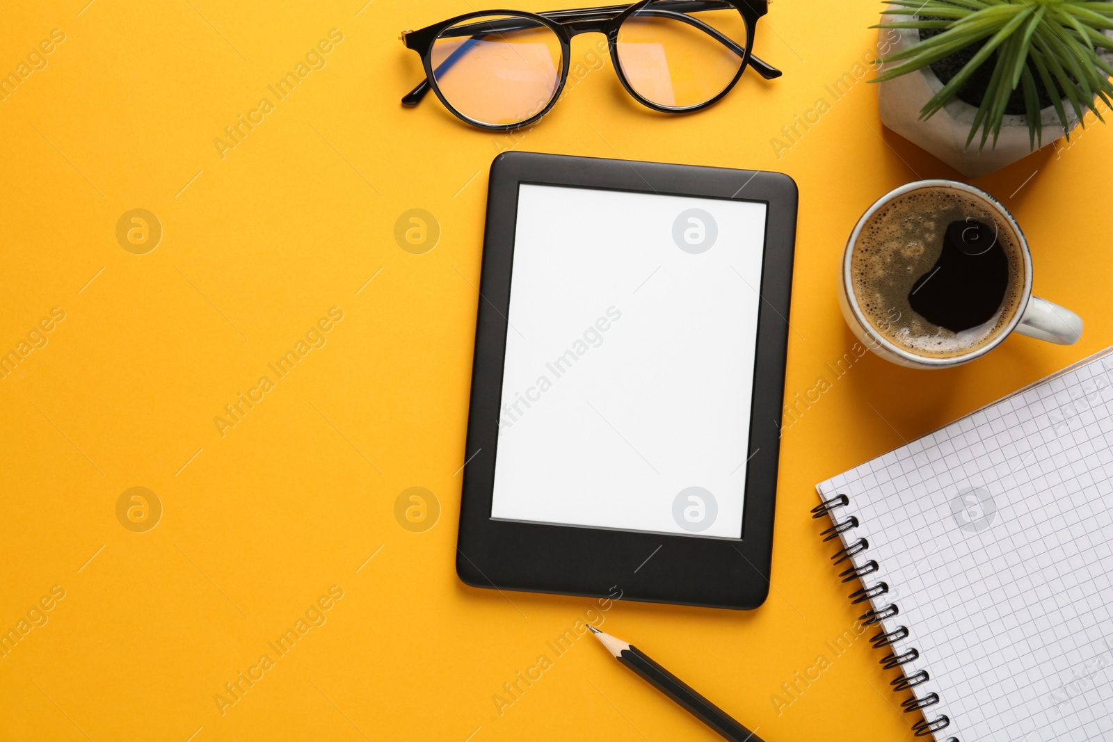 Photo of Flat lay composition with modern e-book reader on orange background, space for text