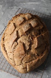 Photo of Freshly baked sourdough bread on grey table, closeup