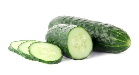 Photo of Whole and sliced fresh cucumbers on white background