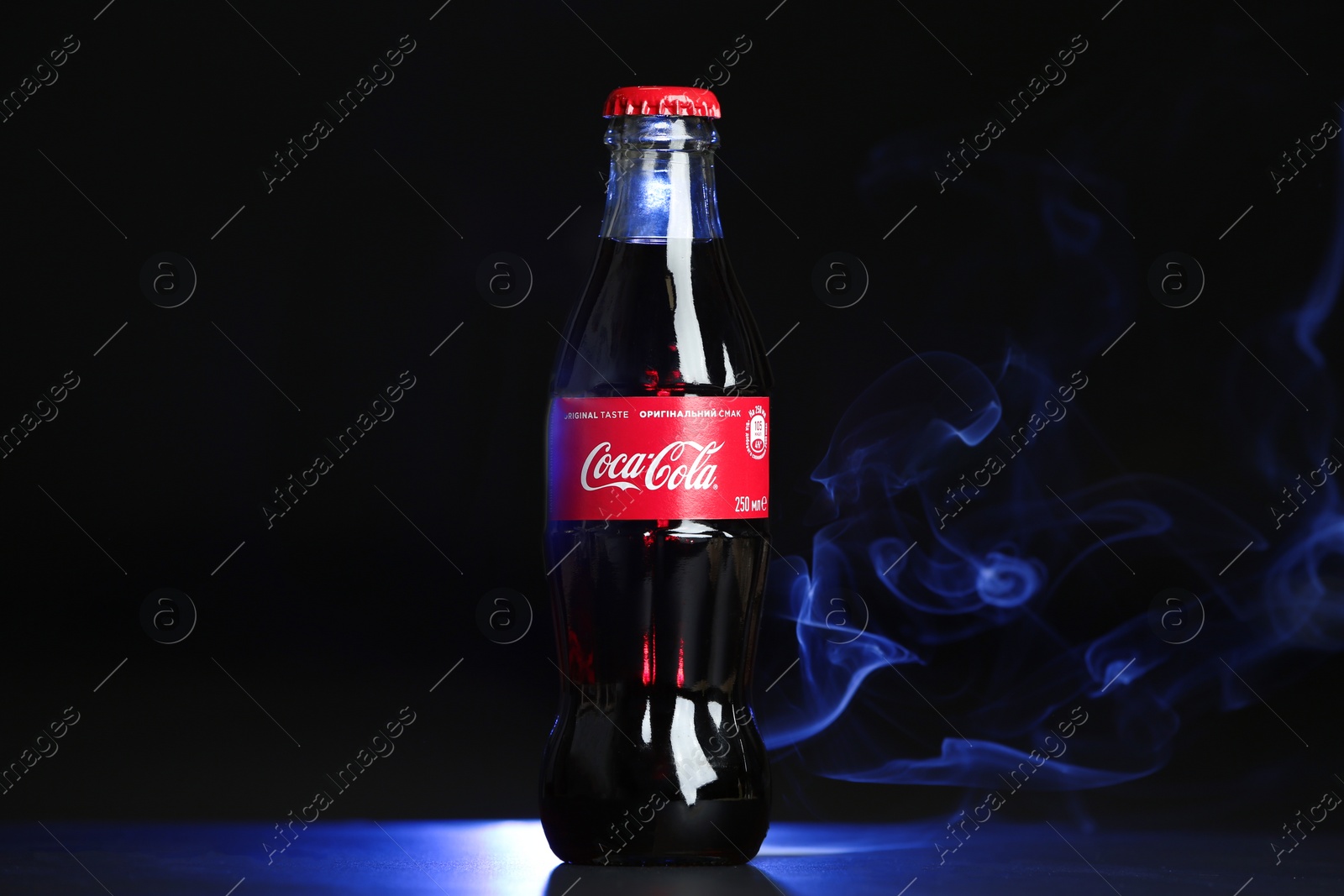 Photo of MYKOLAIV, UKRAINE - NOVEMBER 14, 2018: Bottle of Coca-Cola on dark background