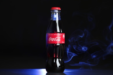 Photo of MYKOLAIV, UKRAINE - NOVEMBER 14, 2018: Bottle of Coca-Cola on dark background