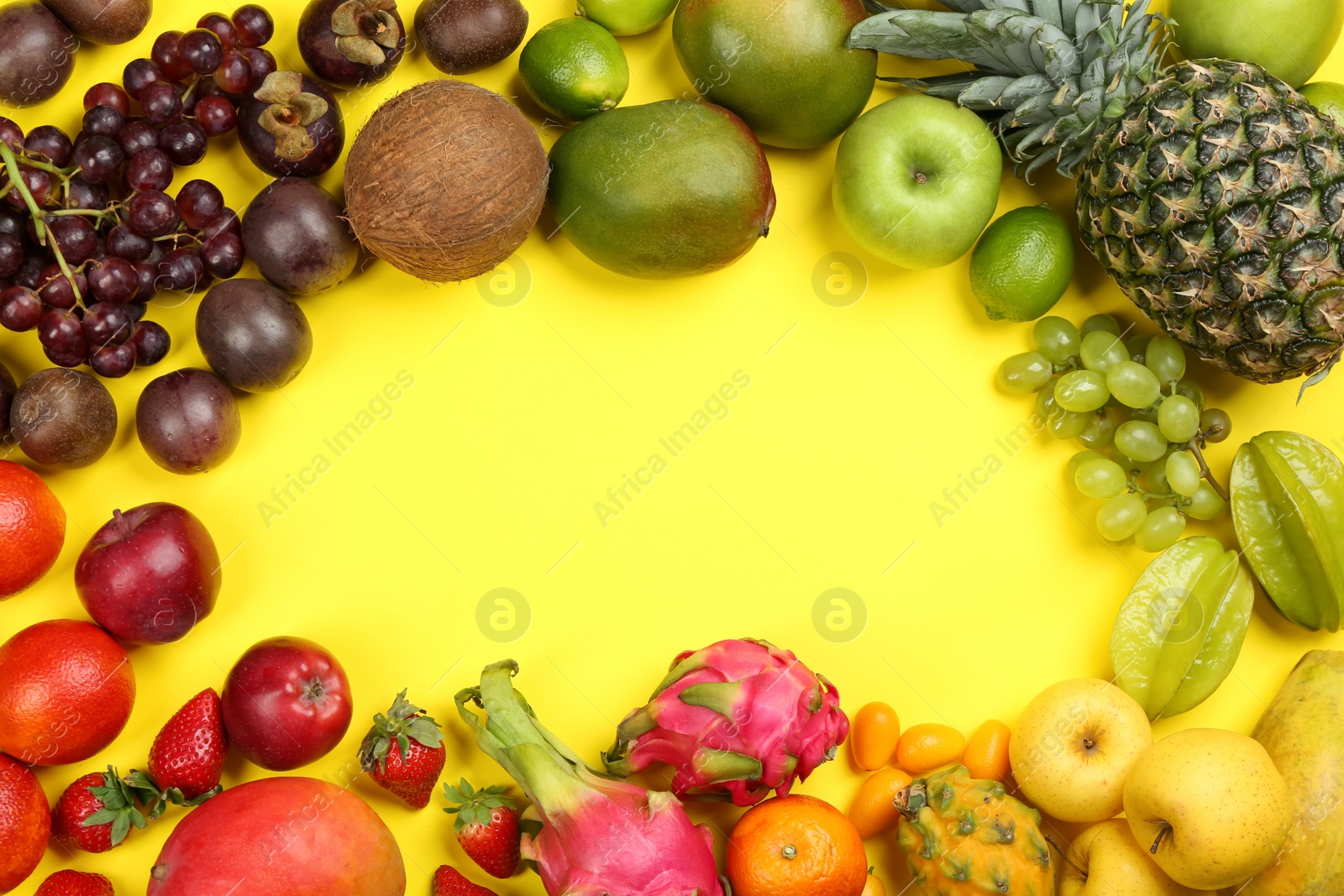 Photo of Frame of fresh exotic fruits on yellow background, flat lay. Space for text