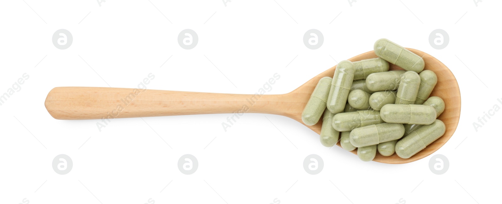 Photo of Vitamin capsules in wooden spoon isolated on white, top view. Health supplement