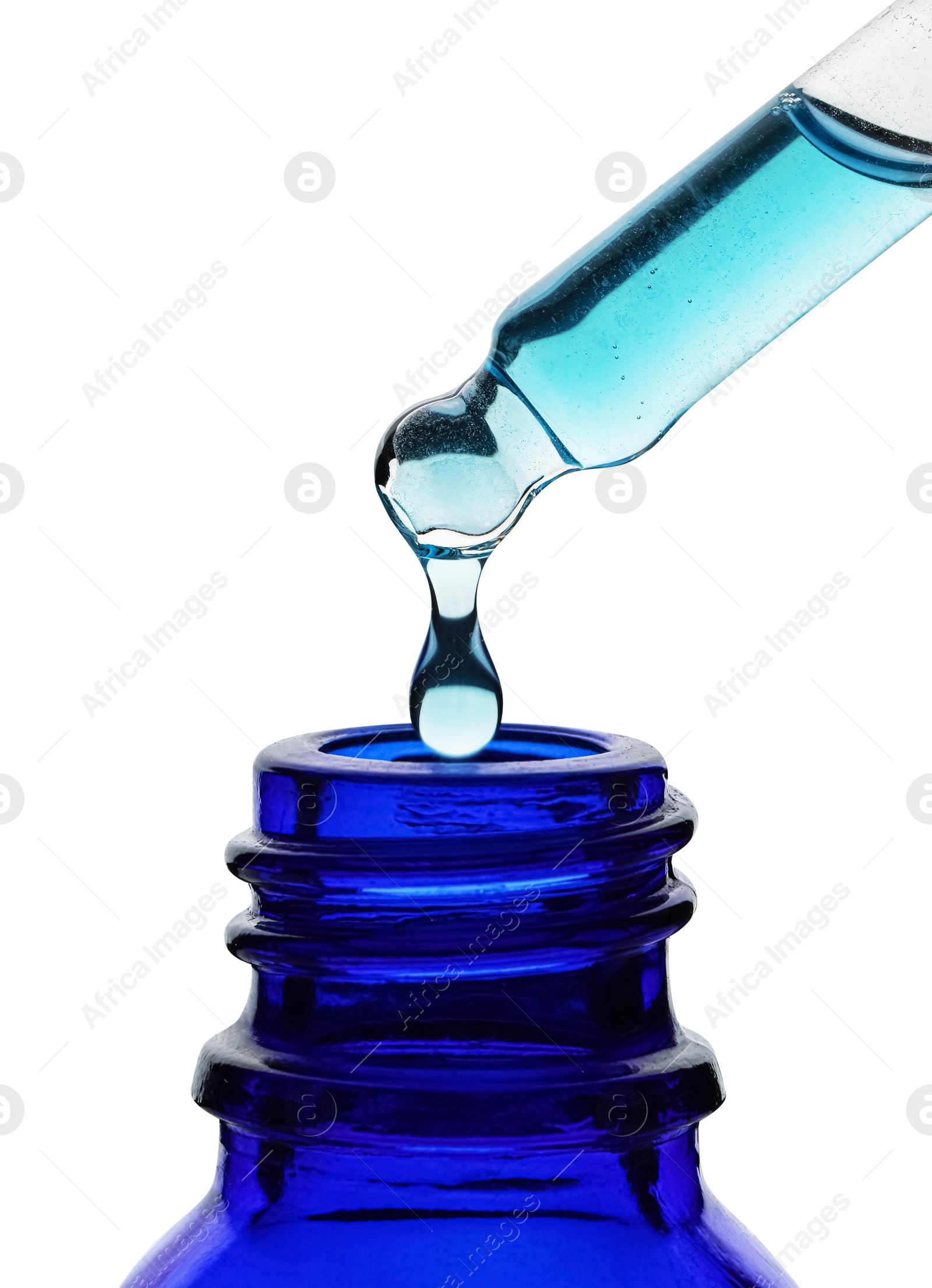 Photo of Dripping light blue facial serum from pipette into glass bottle on white background, closeup