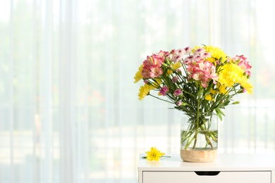 Photo of Vase with beautiful flowers on table near window indoors, space for text. Stylish element of interior design