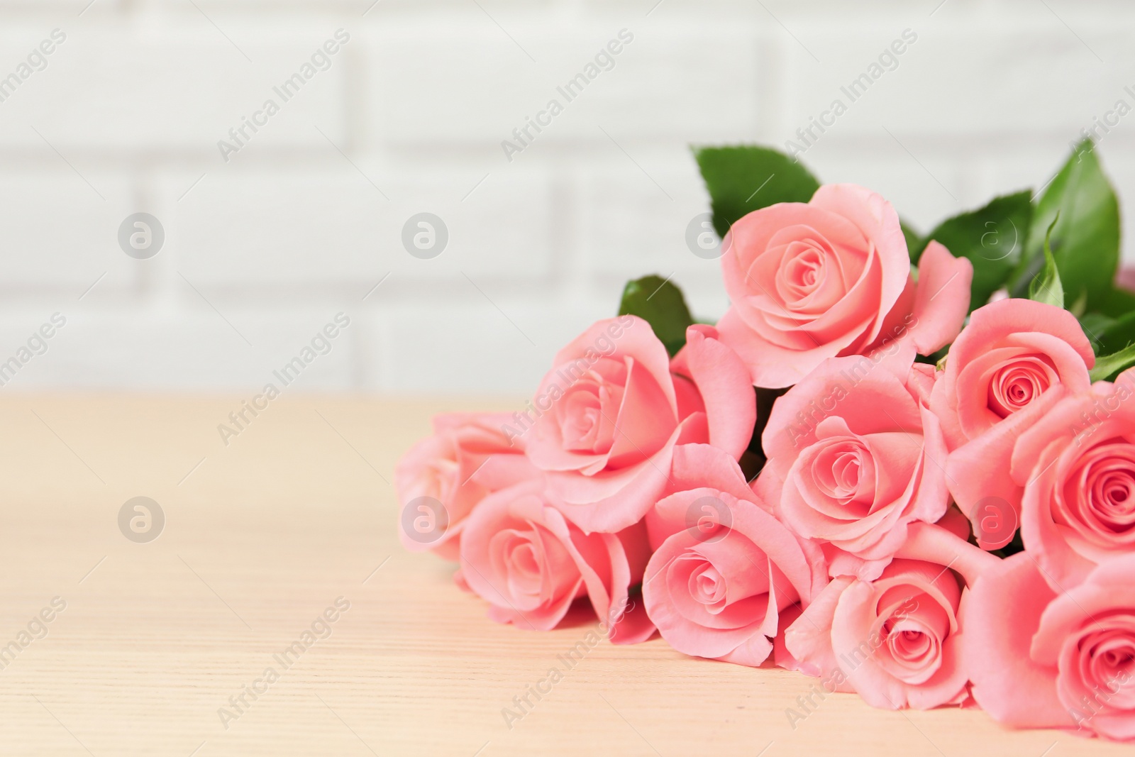 Photo of Bouquet of beautiful roses on table