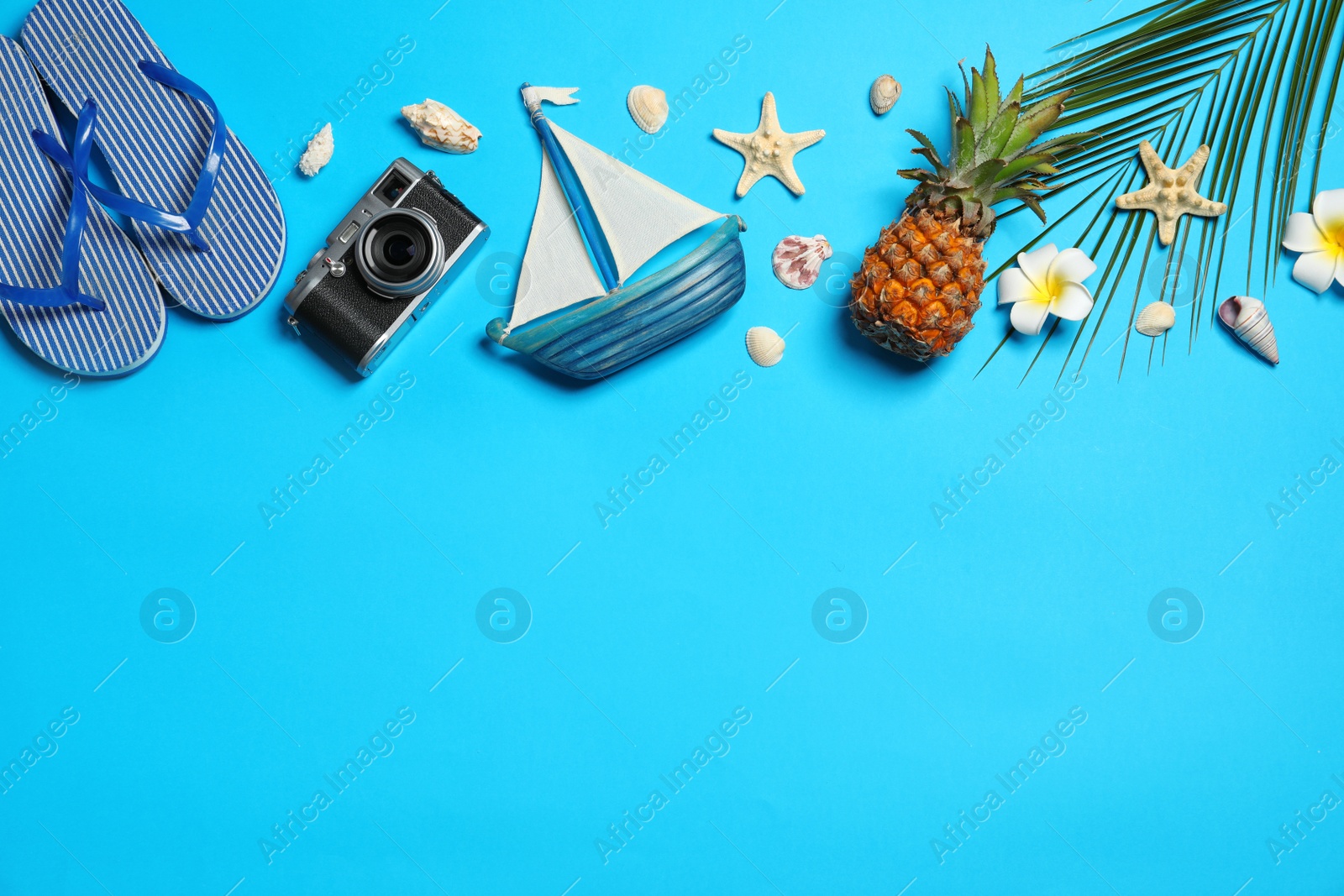 Photo of Flat lay composition with flip flops on color background, space for text. Beach accessories