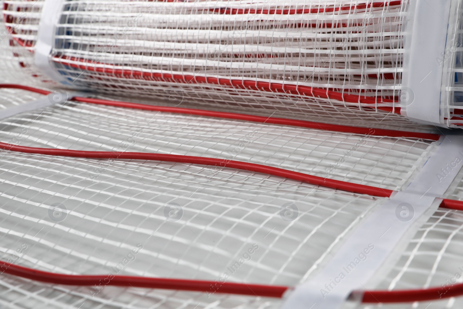 Photo of Installation of modern underfloor trace heating system indoors, closeup