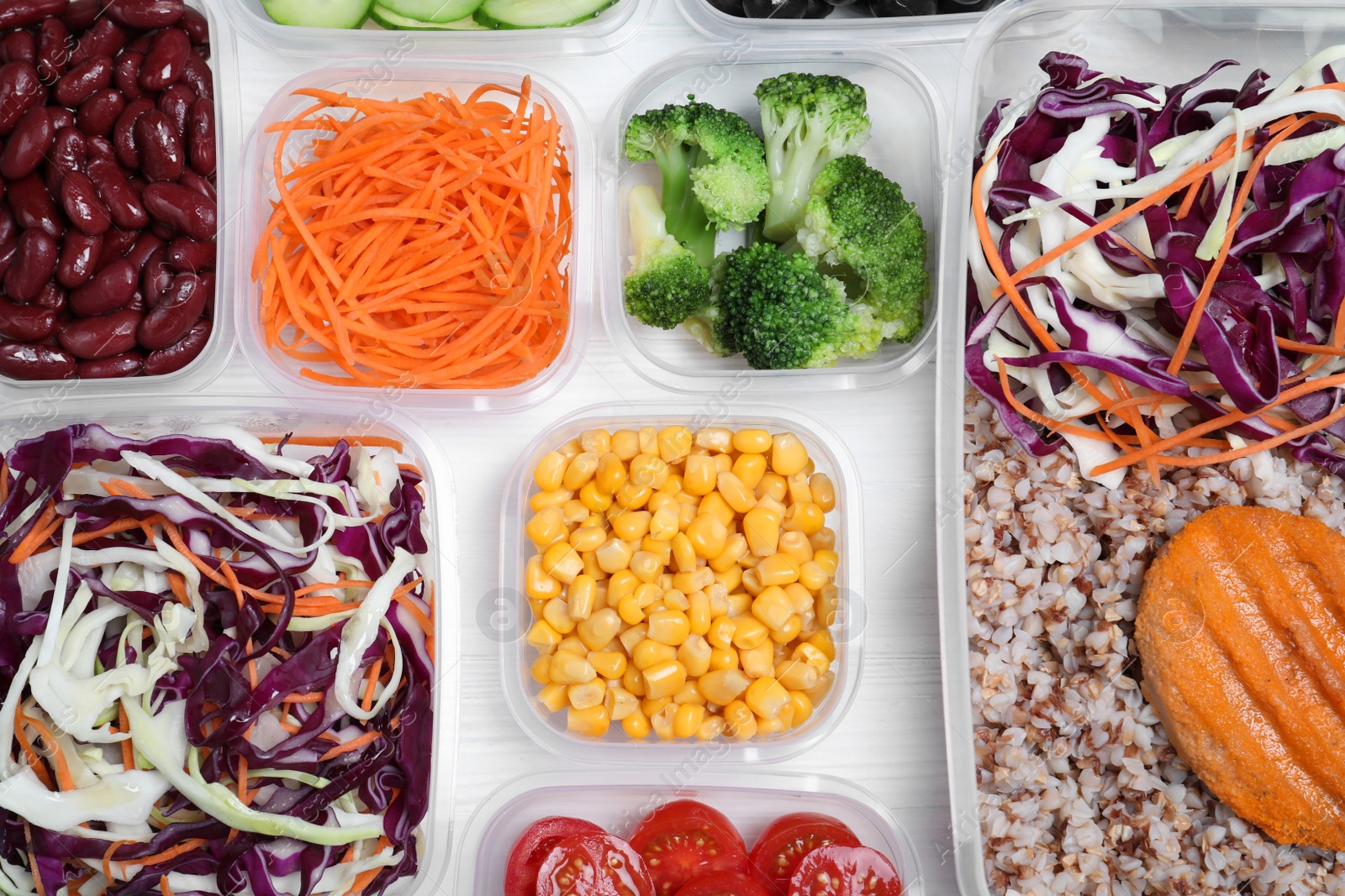 Photo of Set of plastic containers with fresh food on white wooden table, flat lay