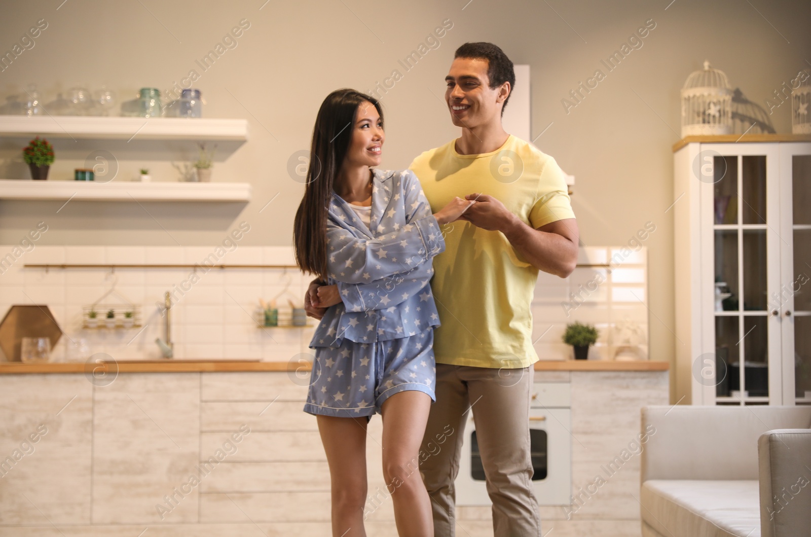 Photo of Lovely young interracial couple dancing at home