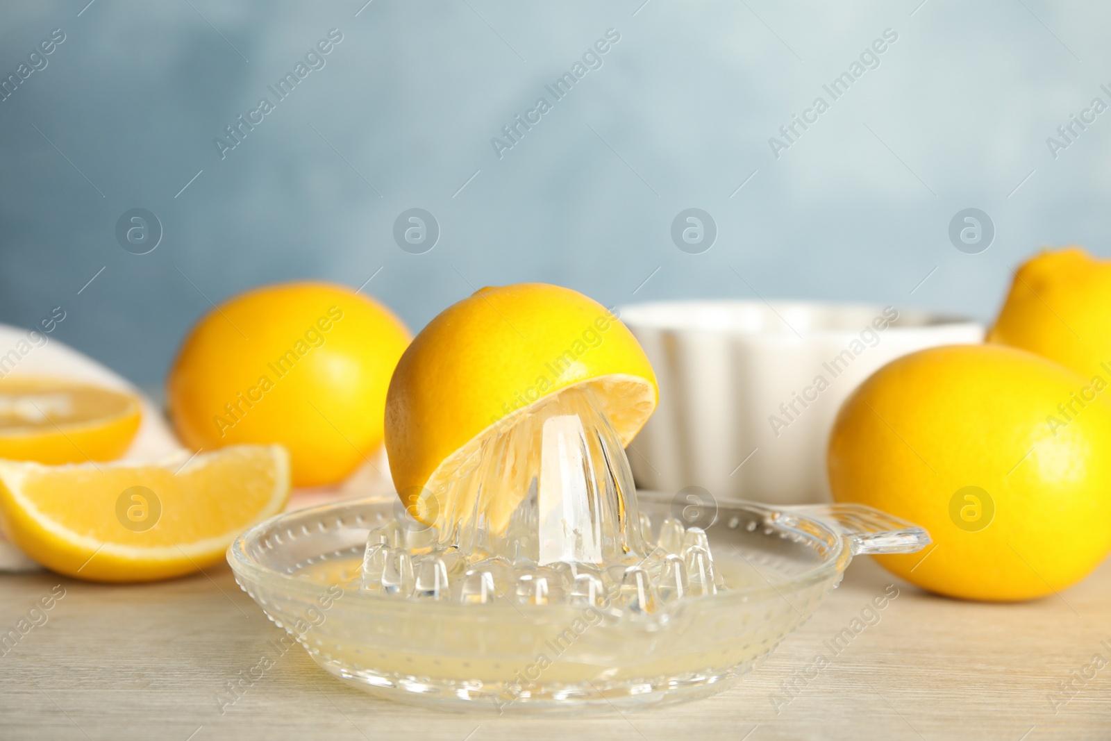 Photo of Freshly squeezed lemon juice on wooden table