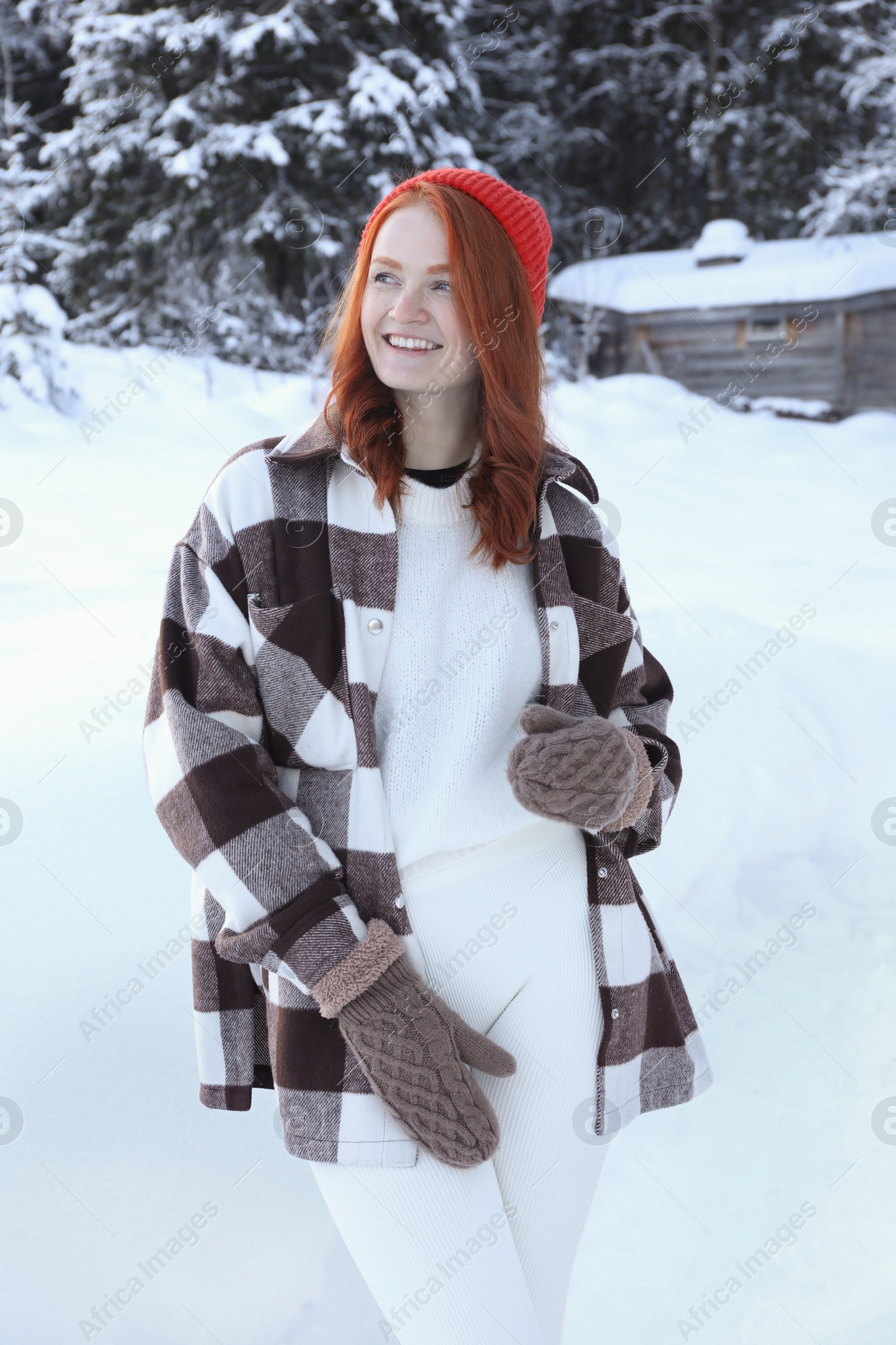 Photo of Portrait of beautiful young woman on snowy day outdoors. Winter vacation