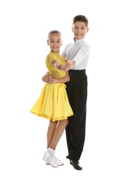 Photo of Beautifully dressed couple of kids dancing on white background