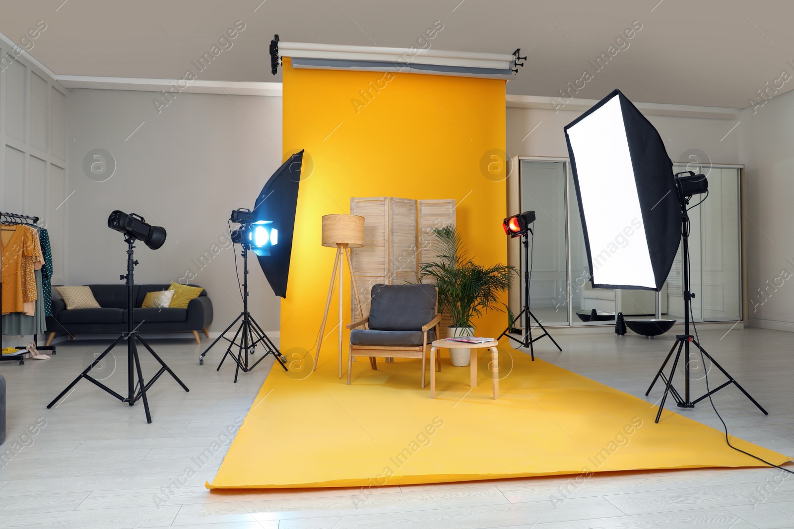 Photo of Stylish furniture in photo studio with professional equipment