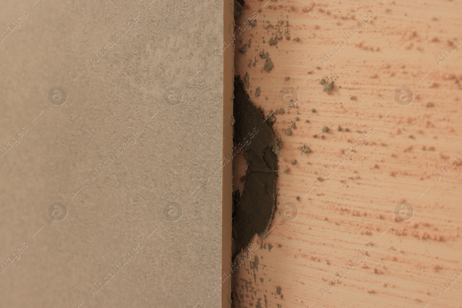 Photo of Adhesive mix and tile on wall, closeup