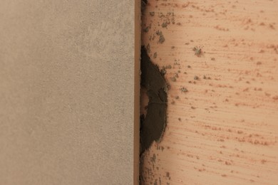 Photo of Adhesive mix and tile on wall, closeup