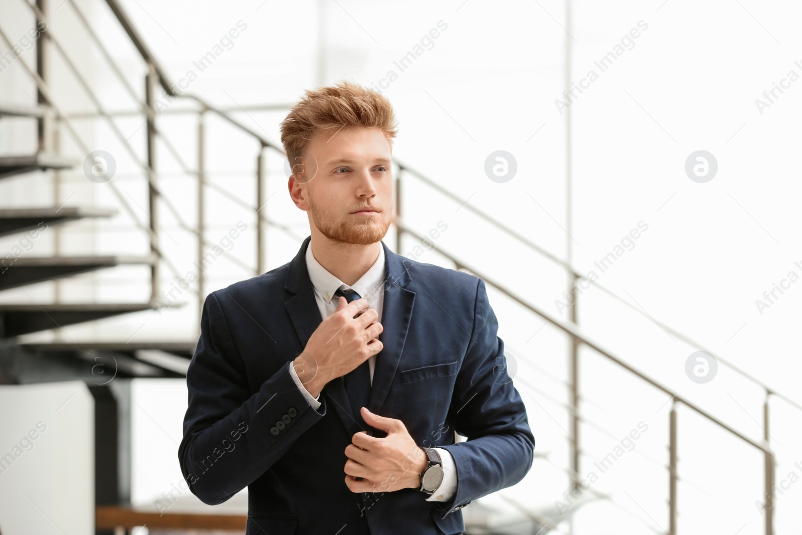 Photo of Portrait of handsome young man in elegant suit indoors