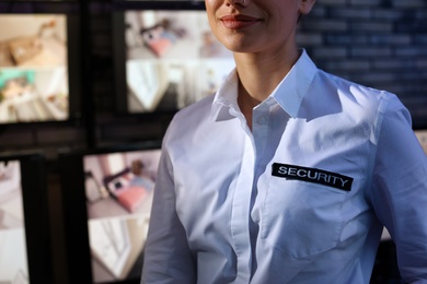 Photo of Female security guard wearing uniform at workplace, closeup