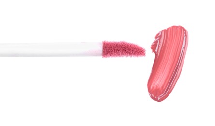 Photo of Stroke of pink lip gloss and applicator isolated on white, top view