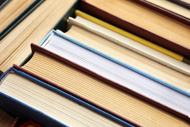 Photo of Many different hardcover books as background, closeup