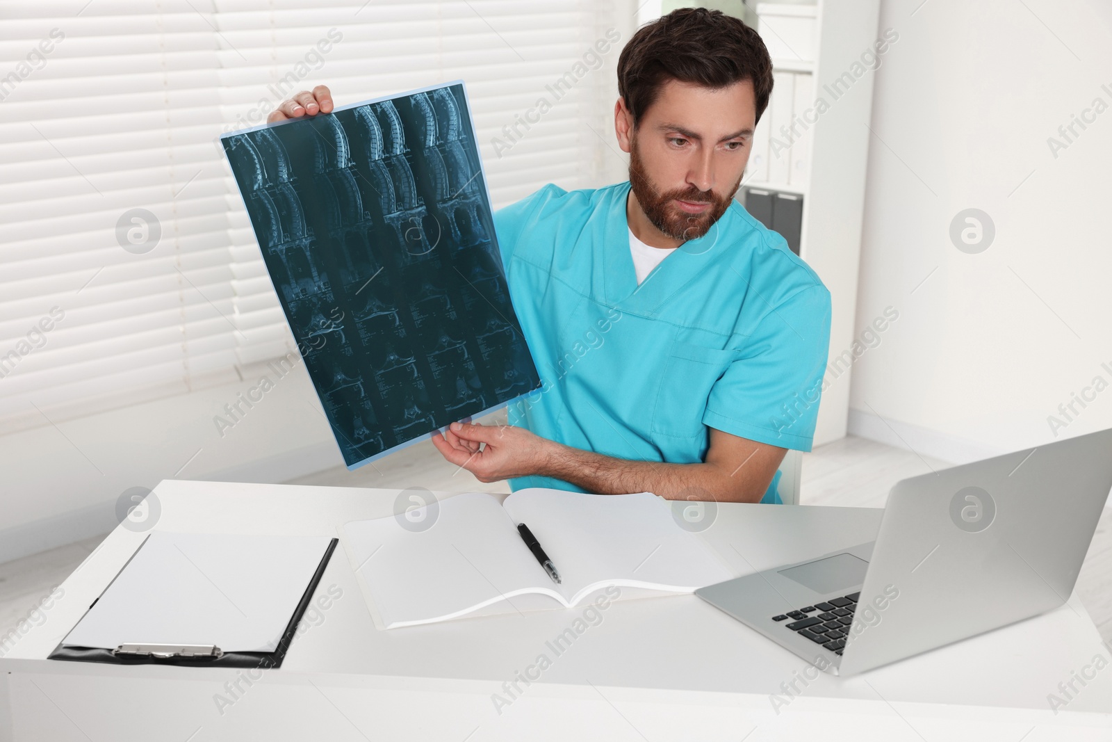 Photo of Doctor explaining MRI scan by videochat in hospital