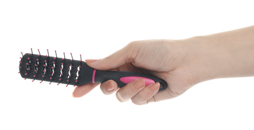 Woman holding vented hair brush on white background, closeup