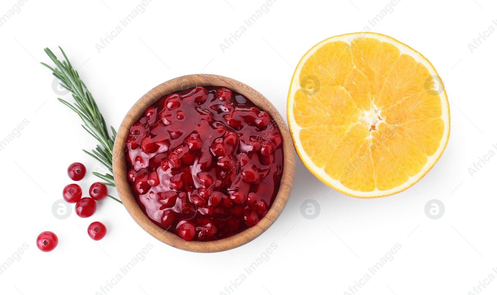 Photo of Tasty cranberry sauce in bowl, fresh berries, orange slice and rosemary isolated on white, top view