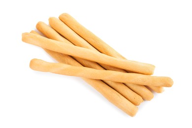 Fresh delicious grissini sticks on white background, top view