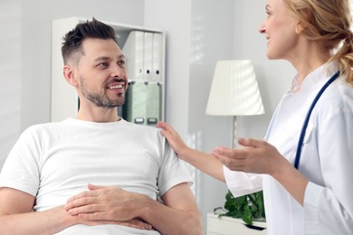 Doctor with stethoscope consulting patient in clinic