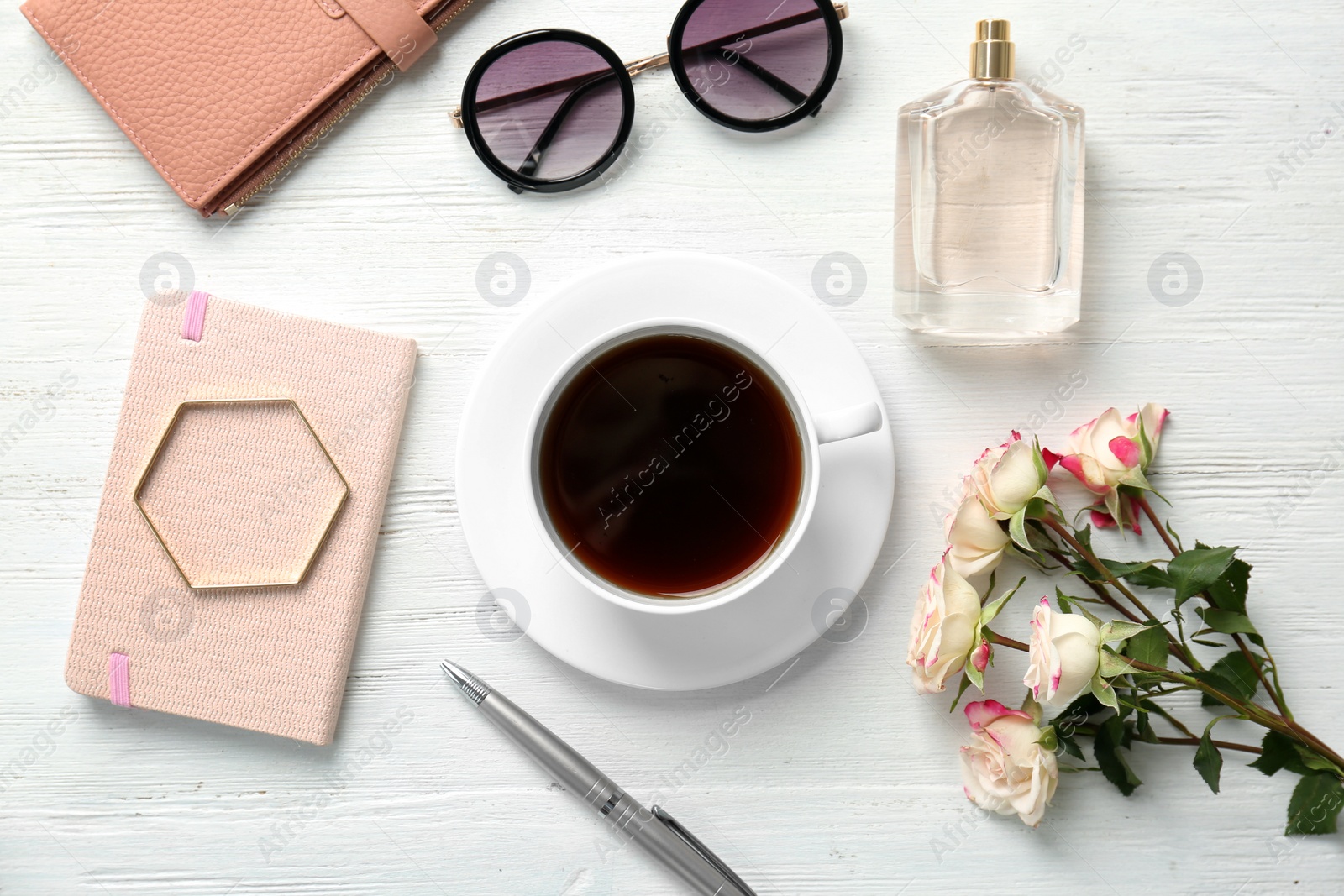 Photo of Flat lay composition with cup of coffee and stylish accessories on light background