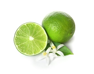 Photo of Ripe limes and flowers on white background. Citrus fruit