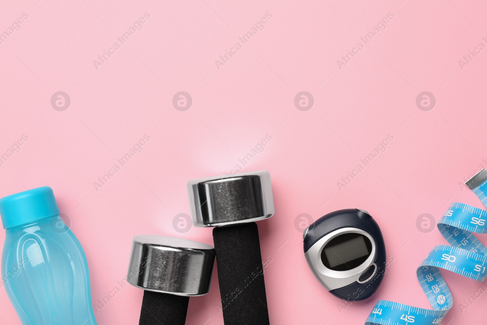 Photo of Flat lay composition with dumbbells on pink background, space for text