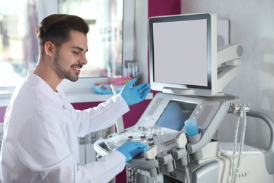 Sonographer using modern ultrasound machine in clinic