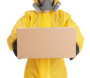 Photo of Man wearing chemical protective suit with cardboard box on white background, closeup. Prevention of virus spread
