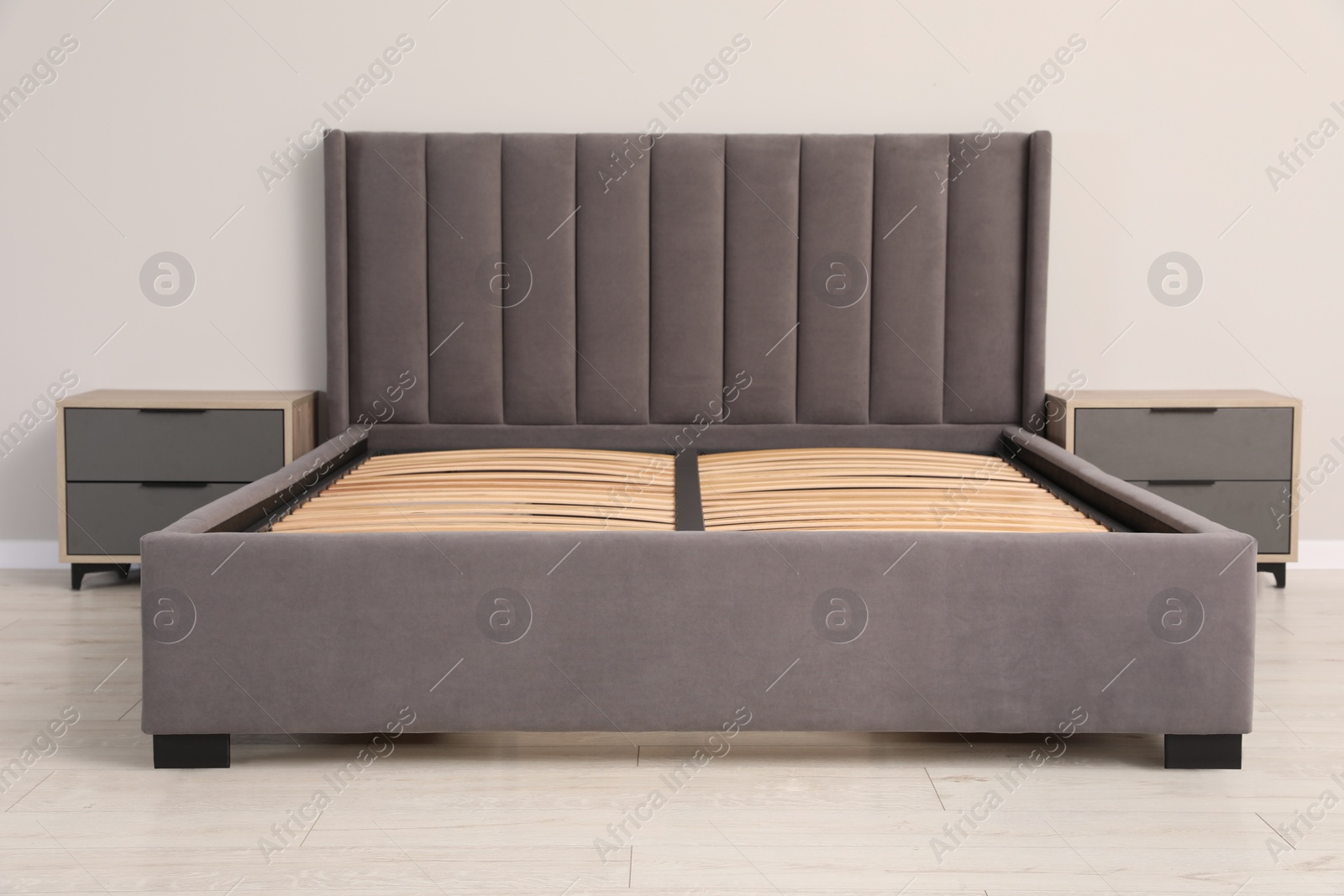 Photo of Comfortable bed with storage space for bedding under slatted base in room