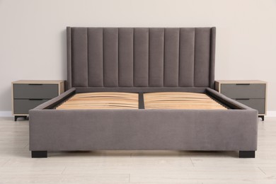 Photo of Comfortable bed with storage space for bedding under slatted base in room