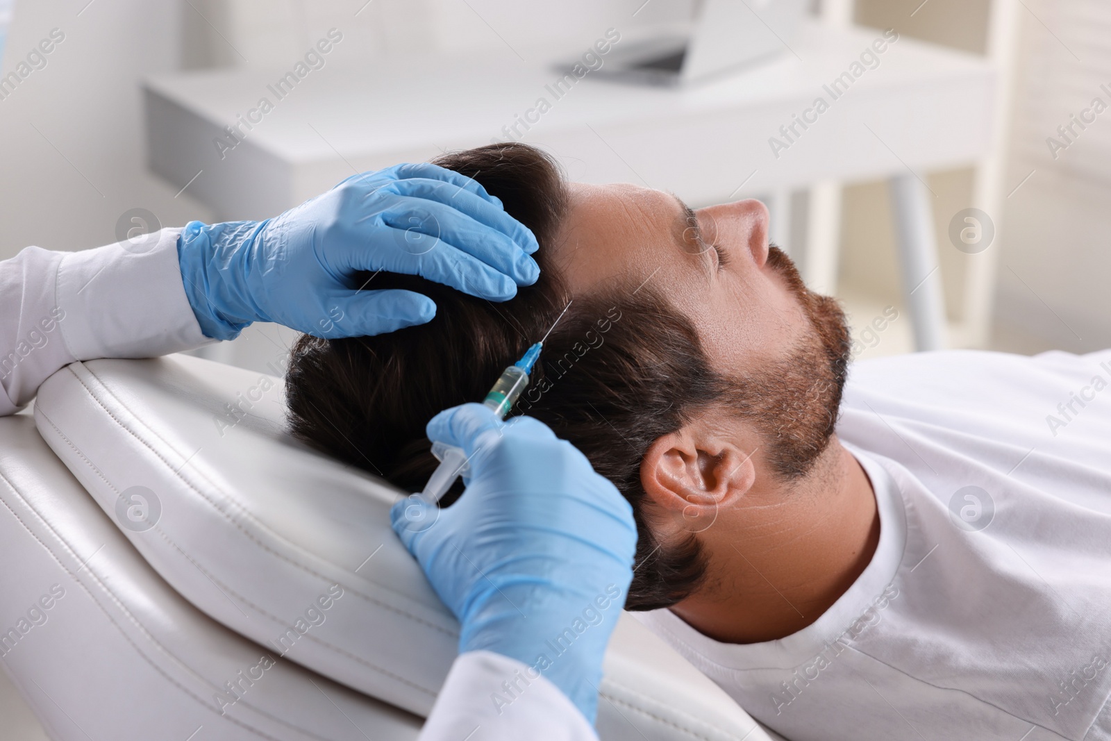 Photo of Trichologist giving injection to patient in clinic, closeup