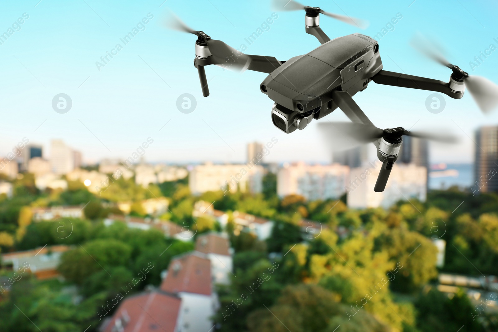 Image of Modern drone flying over city. Aerial survey