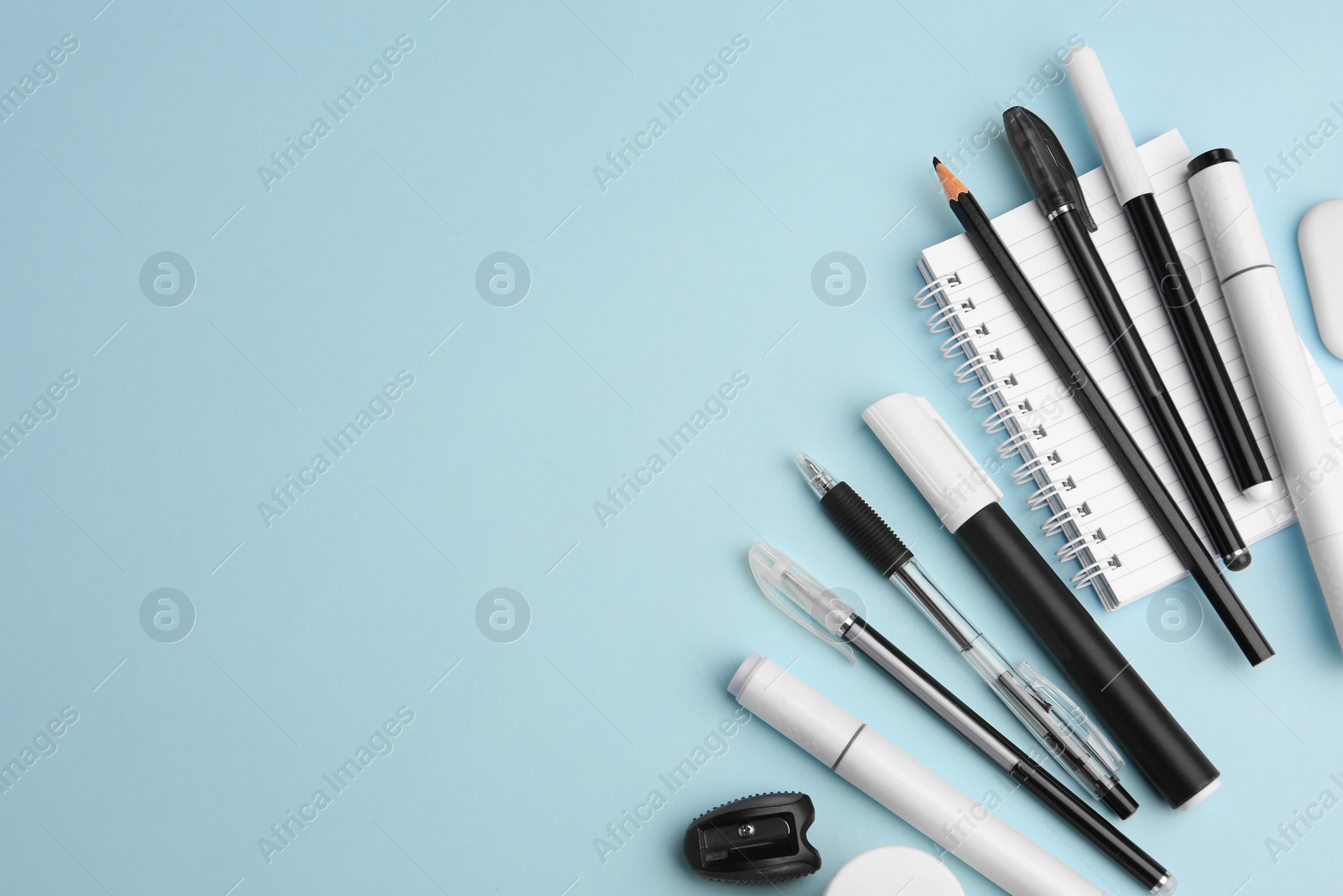 Photo of Flat lay composition with different school stationery on light blue background, space for text. Back to school