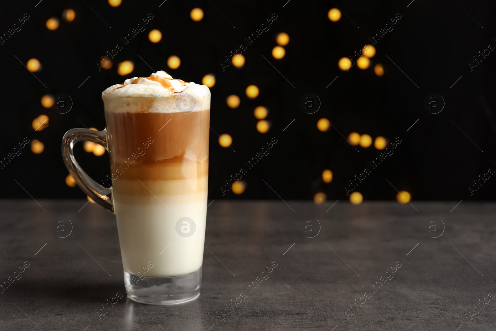 Photo of Glass cup with delicious caramel frappe on table