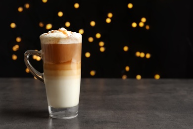 Photo of Glass cup with delicious caramel frappe on table