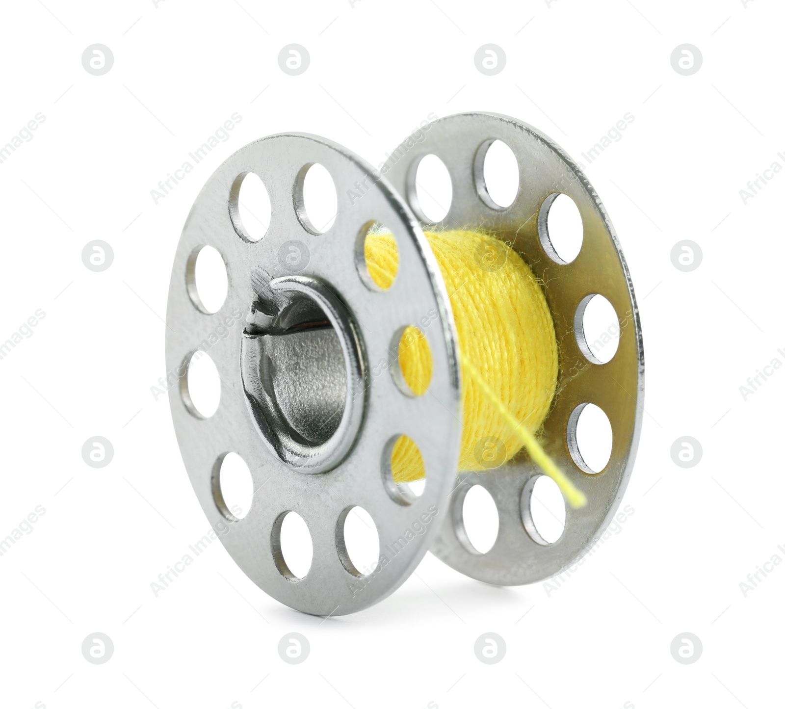 Photo of Metal spool of yellow sewing thread isolated on white