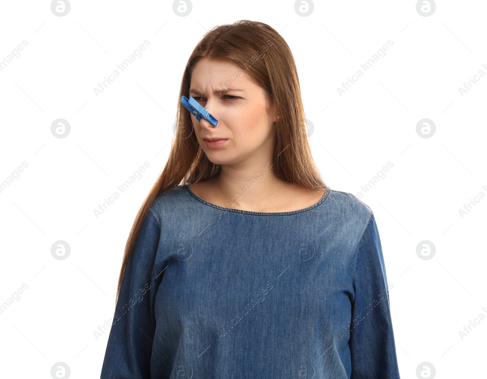 Photo of Young woman with clothespin on white background. Runny nose concept